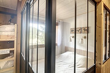 A bedroom with a bed and bunk beds and a sign that says