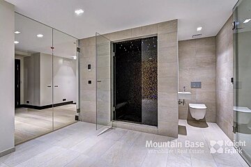 A bathroom with a knight frank logo on the wall