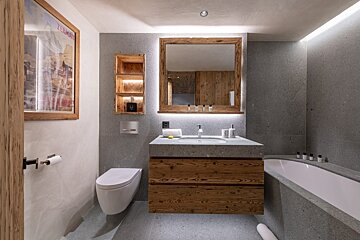 A bathroom with a picture on the wall that says l' alpe