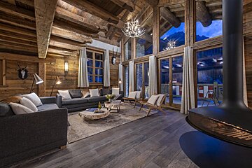 A living room with a couch and chairs and a fireplace