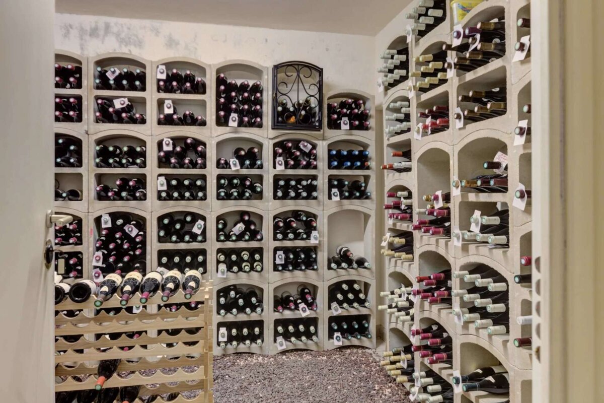 A wine cellar filled with lots of bottles including one labeled ' a '
