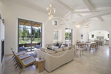 A living room with a couch and chairs and the letter j on the wall