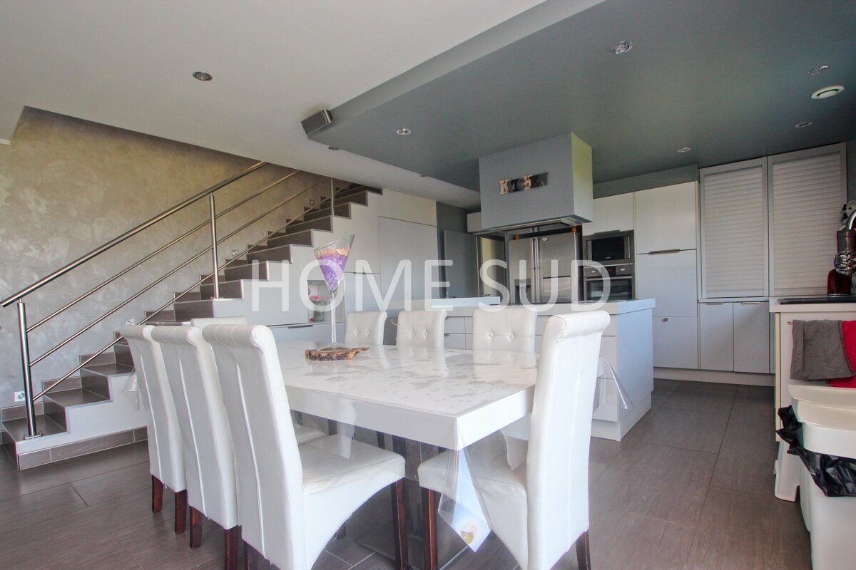 A kitchen with a table and chairs and the words home sud on the ceiling