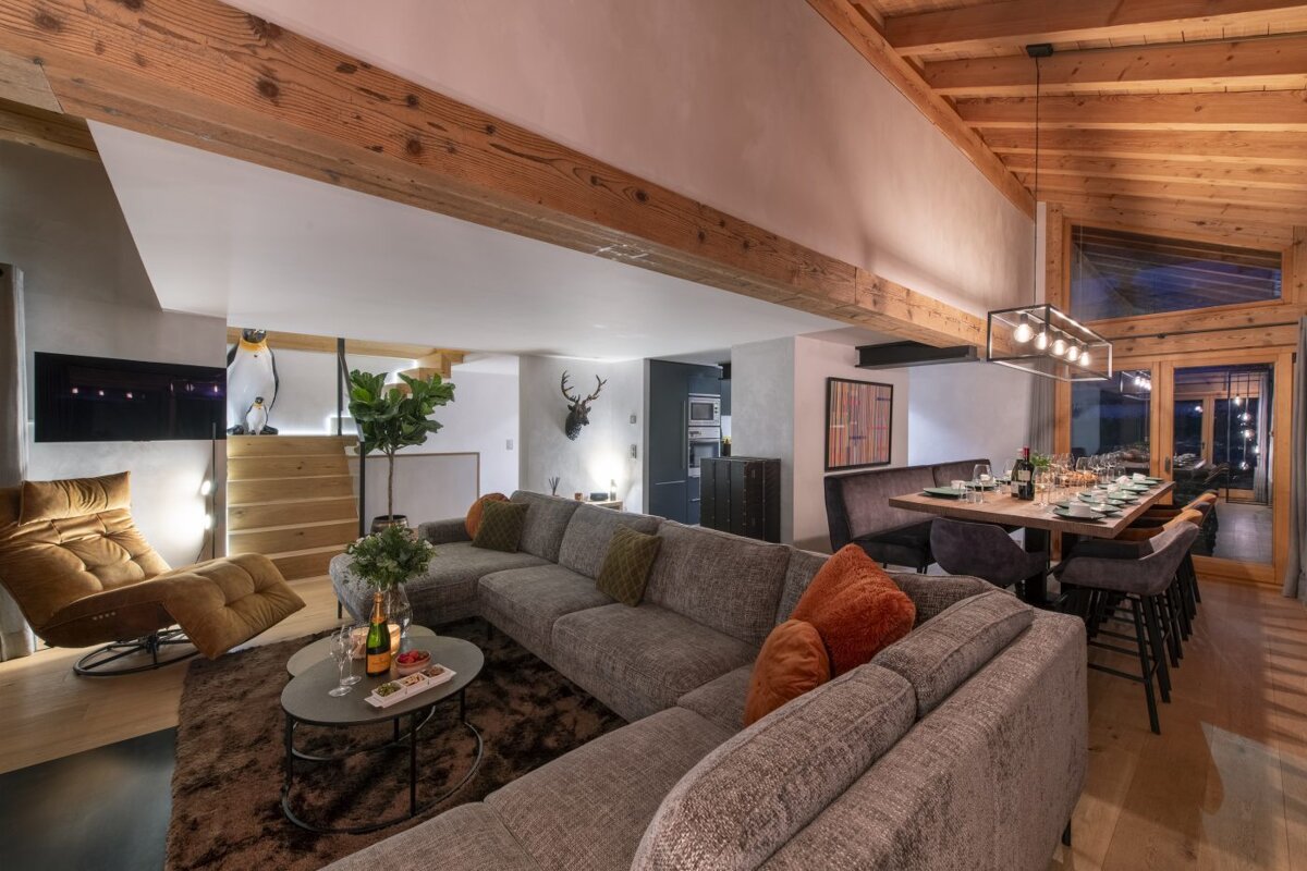 A living room with a large sectional couch and a chair