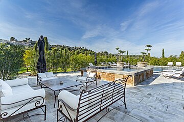 A patio with a table and chairs and a fountain