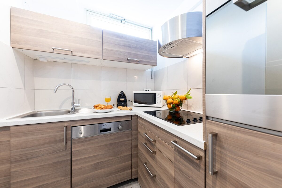 A kitchen with wooden cabinets and a siemens dishwasher