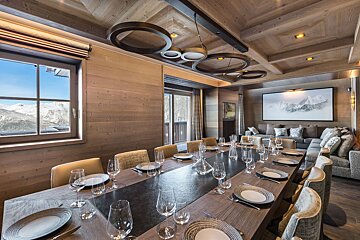 A long dining table with plates and glasses on it