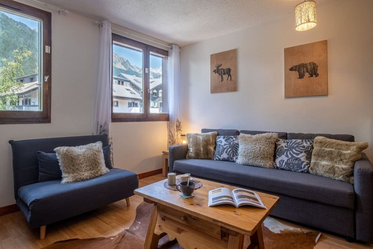 A living room with a couch a chair and a coffee table