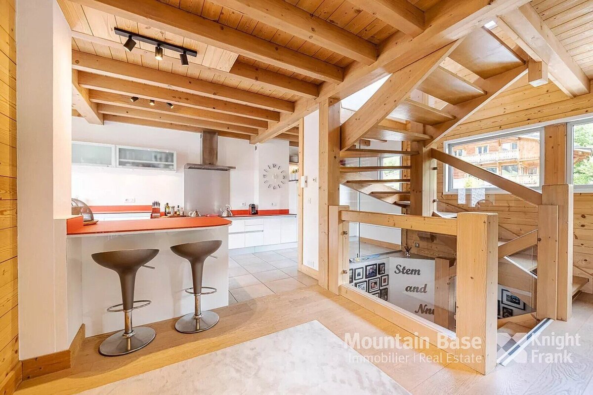 A kitchen with stools and a sign that says stem and new
