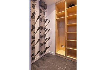 A closet with a helmet hanging on the wall