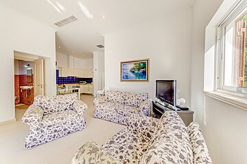 A living room with two couches and a flat screen tv