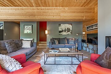 A living room with a couch and two chairs