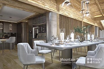 Elegant modern chalet interior with an open-plan kitchen and dining area. Features warm wood, stylish grey furniture, candles, and a wine display.