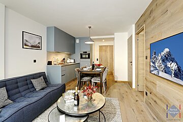 A kitchen with blue cabinets and a table set for dinner