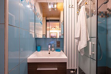 A bathroom with blue and white tiles and a sink