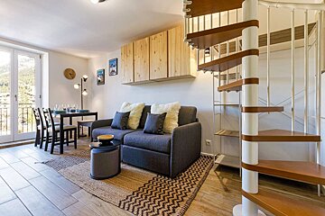 A living room with a spiral staircase and a couch