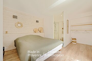 A bedroom with a bed made in provence by immobilier