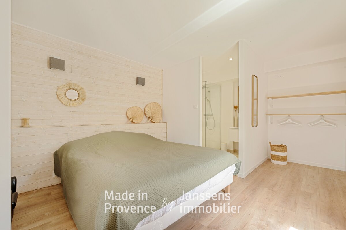 A bedroom with a bed made in provence by immobilier