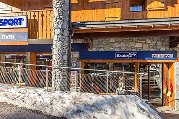 A store front with a blue awning that says boutique