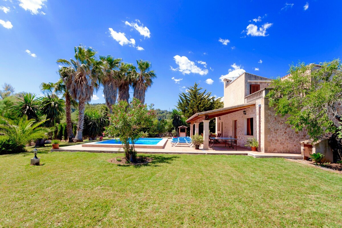 A large house with a swimming pool in the backyard