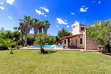 A large house with a swimming pool in the backyard