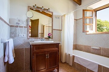 A bathroom with a sink a mirror and a window