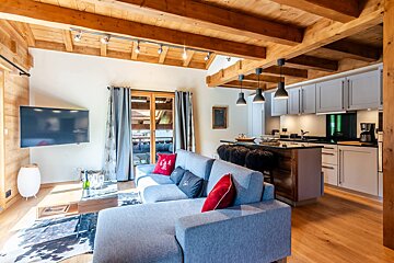 A living room with a couch and a flat screen tv