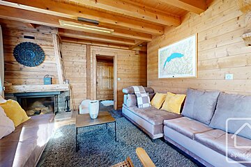 A living room with a couch a fireplace and a map on the wall