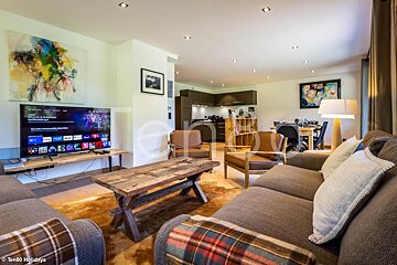 A living room with a couch and a flat screen tv