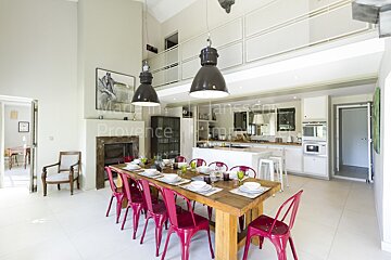 A dining room with a table and chairs and a sign that says provence