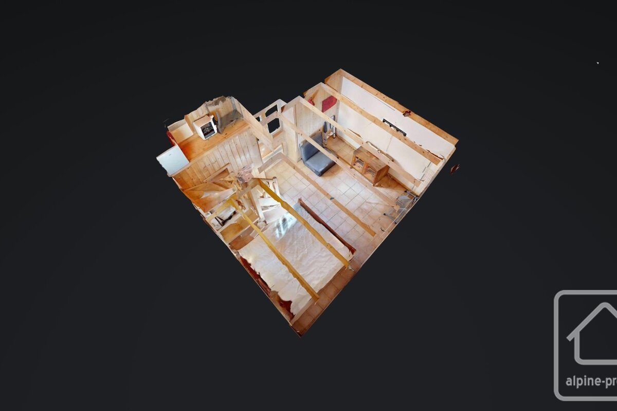 Aerial 3D model of an unfinished room, showing wooden walls, tiled floor, a bed, and other items.