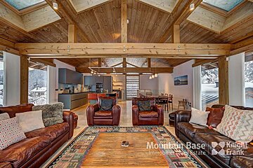 A living room with a couch and two chairs and the words mountain base on the bottom