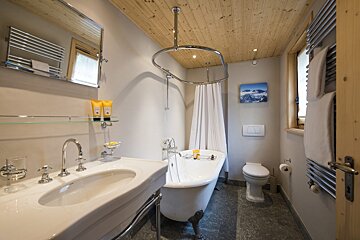 A bathroom with a tub a sink and a toilet