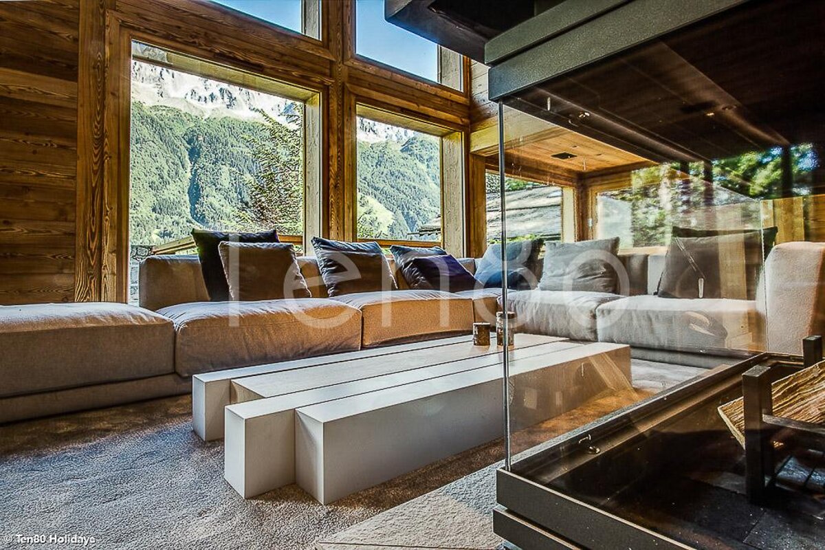 A living room with a couch and a table with the word holidays on the bottom