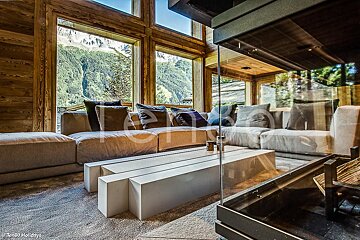 A living room with a couch and a table with the word holidays on the bottom