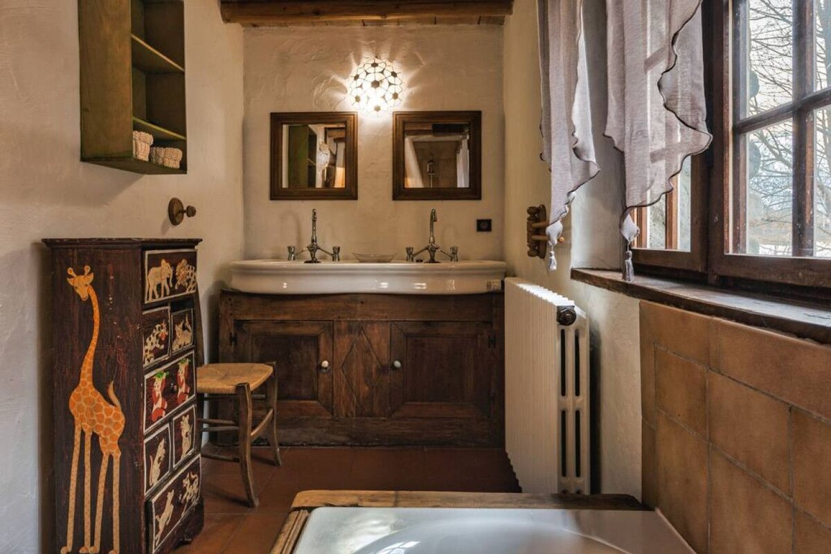 A bathroom with two sinks and a giraffe dresser
