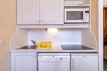 A small kitchen with a microwave and a dishwasher