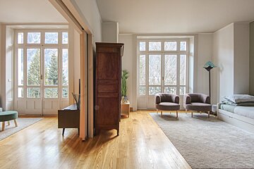A living room with two chairs and a dresser