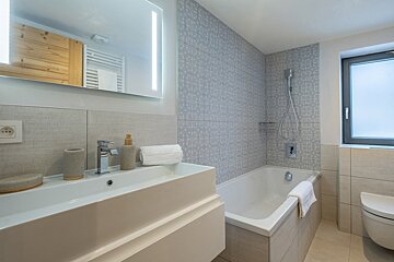 A bathroom with a bathtub and a sink