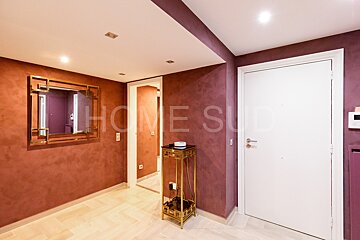 A hallway with purple walls and the word home on the wall