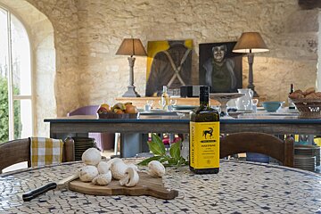 A bottle of huile d' olive sits on a table