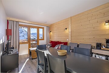 A living room with a dining table and chairs