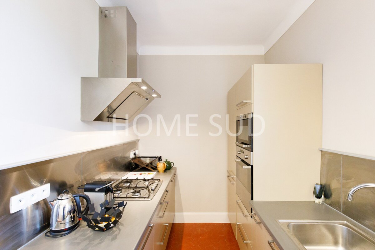 A kitchen with the word home on the wall