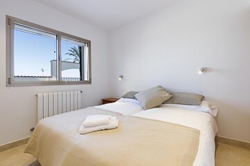 A bedroom with a large bed and a window