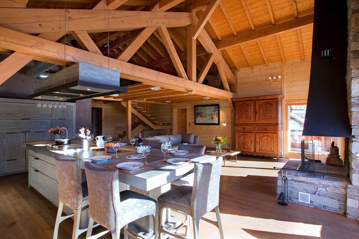 A kitchen and dining area in a wooden house