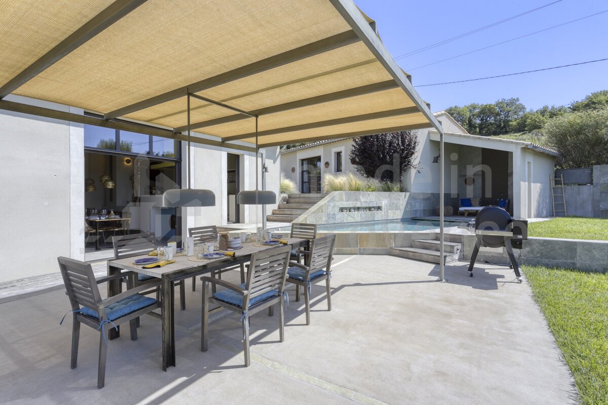 A patio with a table and chairs under a canopy