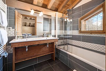 A bathroom with a wooden sink and a bathtub