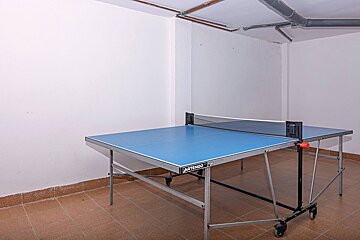 A blue ping pong table that says artemis on it