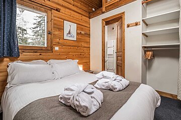 A bedroom with a picture of a skier on the wall