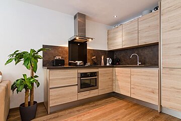A kitchen with wooden cabinets and stainless steel appliances